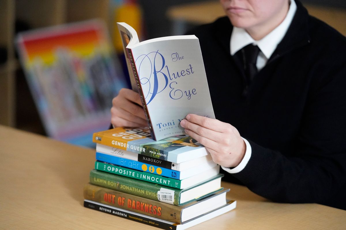 Amanda Darrow, director of youth, family and education programs at the Utah Pride Center, poses with books Dec. 16 that have been the subject of complaints from parents in Salt Lake City  (Rick Bowmer)
