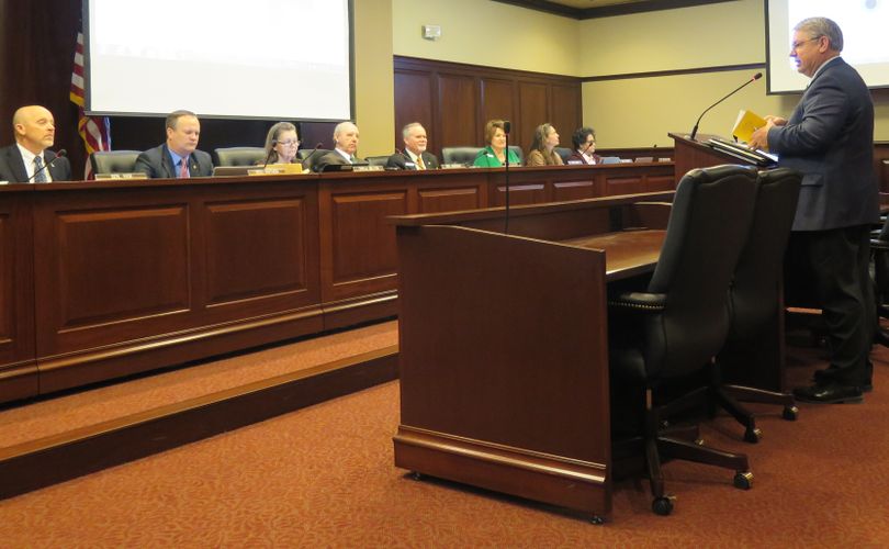 Idaho Secretary of State Lawerence Denney holds a copy of Idaho's Sunshine Law Manual, as he addresses the Senate State Affairs Committee on Friday, March 16, 2018, about major campaign finance reform legislation that's being proposed by a legislative interim working group; a formal interim committee will continue work on the bill between now and next year's legislative session. (The Spokesman-Review / Betsy Z. Russell)