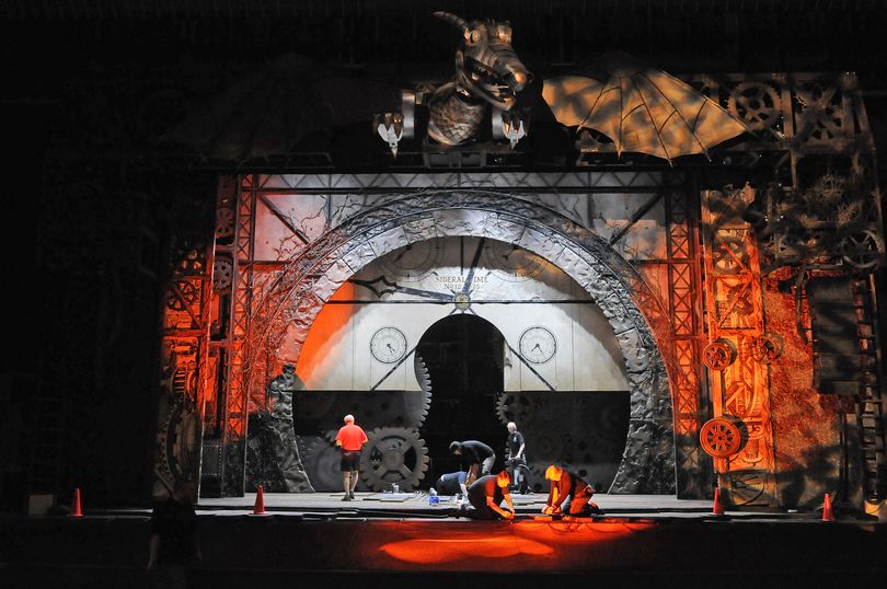 Wicked work: Stage crews are bathed in orange as lights are tested and the set of the Broadway blockbuster “Wicked” is assembled on Tuesday in the INB Performing Arts Center in Spokane. The show travels with 13 semitrailers filled with props and sets and takes crews 2 ½ days to set up. “Wicked” runs today through May 29. (Dan Pelle)