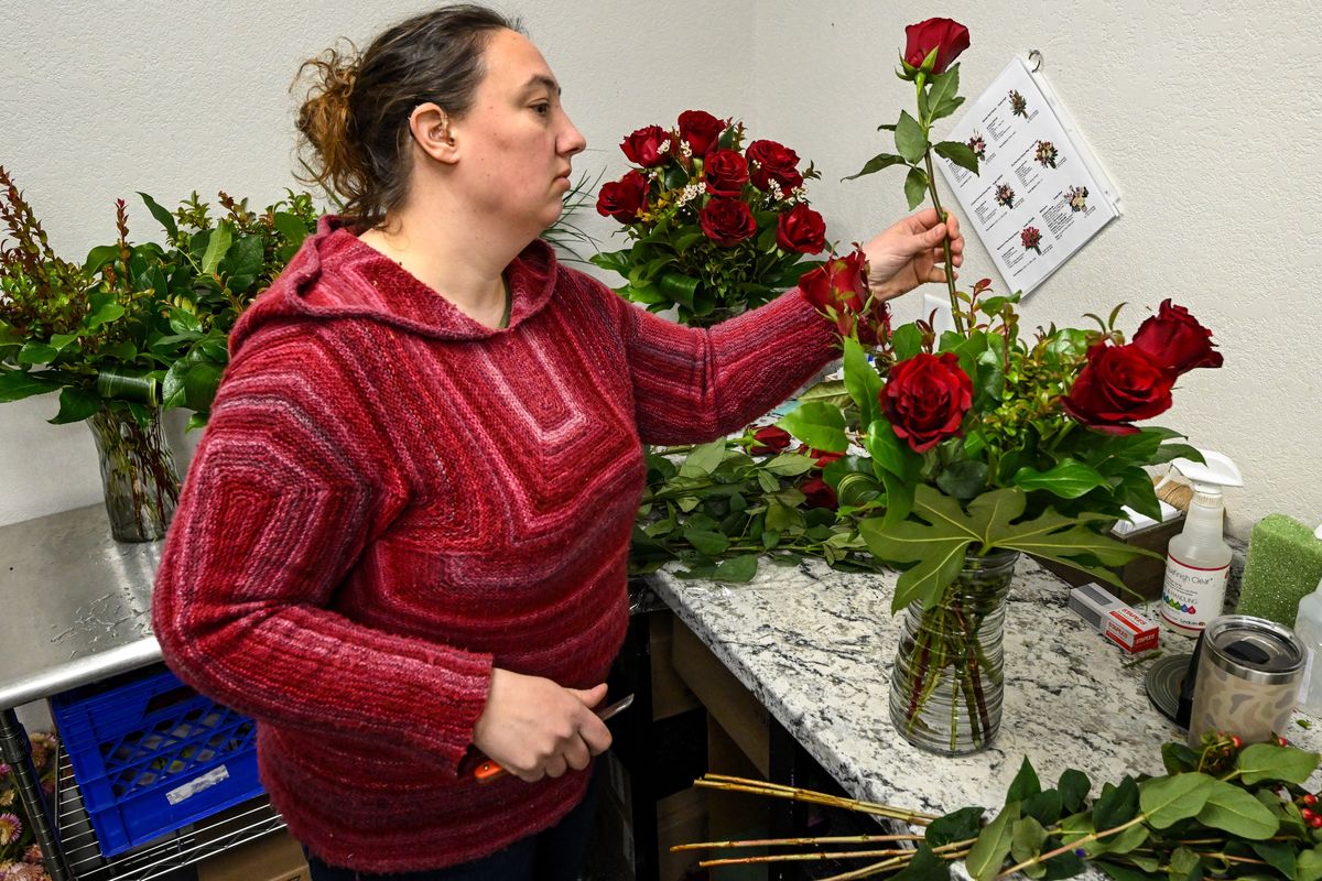 Rose and Blossom floral designer Cate True makes Valentine’s Day red rose arrangements, Wednesday.  (COLIN MULVANY/THE SPOKESMAN-REVIEW)