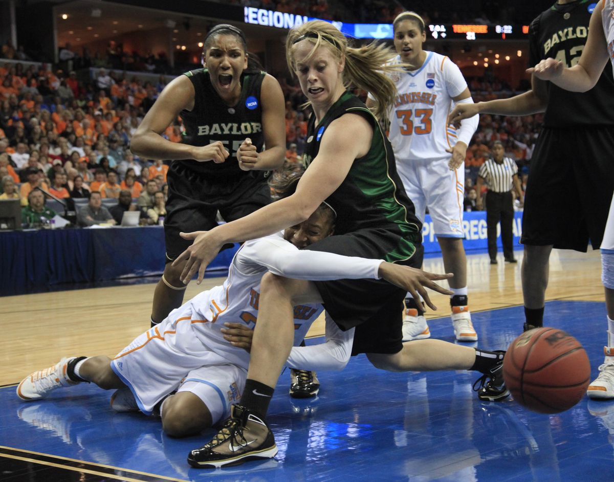 Tennessee forward Glory Johnson falls as she passes the ball around Baylor guard Melissa Jones during the first half. (Associated Press)