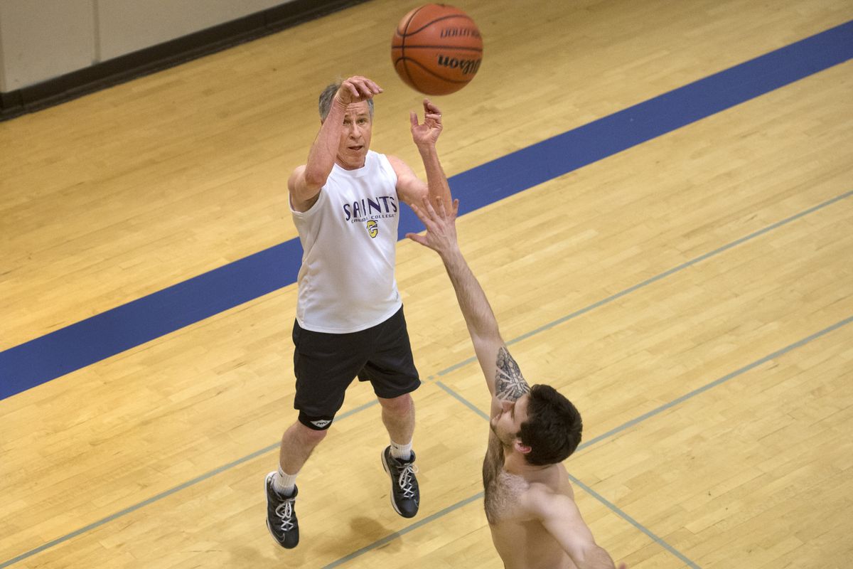 Gonzaga University accounting professor Eddy Birrer launches a jump shot over Samuel Pipes during a lunchtime basketball game Feb. 13 in the Martin Centre. (Dan Pelle)