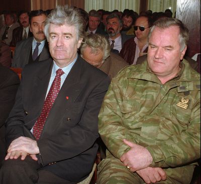 In this April, 15 1995 file photo, Bosnian Serb Leader Radovan Karadzic, left, and Bosnian Serb Army commander General Ratko Mladic, right, listen during a Bosnian Serb assembly session in the western Bosnian town of Sanski.  Mladic, Europe's most wanted war crimes fugitive, has been arrested in Serbia, the country's president said Thursday, May 26, 2011. Mladic has been on the run since 1995 when he was indicted by the U.N. war crimes tribunal in The Hague, Netherlands, for genocide in the slaughter of some 8,000 Bosnian Muslims in Srebrenica and other crimes committed by his troops during Bosnia's 1992-95 war.  (Sava Radovanovic / Associated Press file)