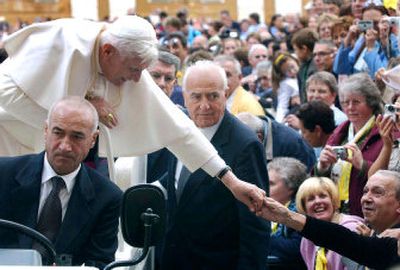 
Pope Benedict XVI reaches out to touch the hand of a pilgrim as he is driven through the crowd during his weekly general audience at the Vatican Wednesday. 
 (Associated Press / The Spokesman-Review)