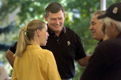 
UI President Timothy White, center, and his wife, Karen, greet guests at their campus residence during an open house earlier this month. 
 (Christopher Anderson/ / The Spokesman-Review)