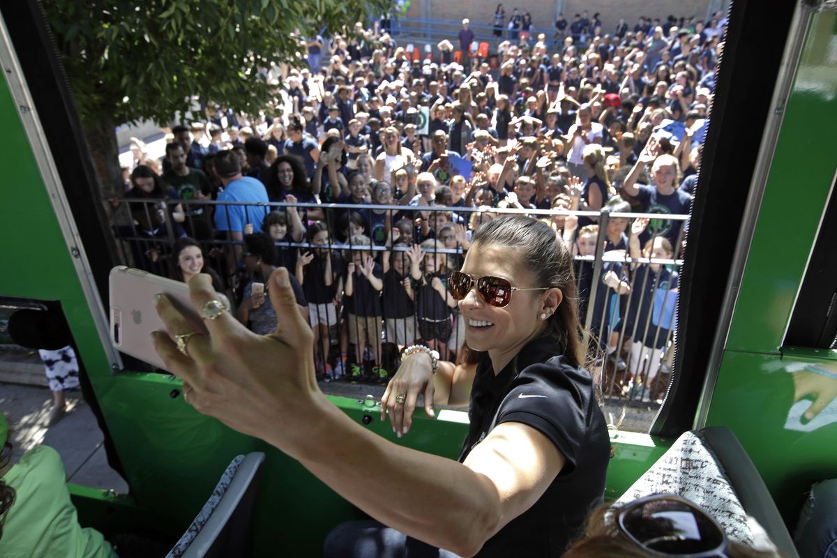 NASCAR driver Danica Patrick takes a selfie from a tour trolley car as students from the Warren-Prescott school give her a send-off rally for a tour of historic sites, Wednesday, June 14, 2017, in Boston. Patrick says she “had a moment” when she lost her temper at a booing fan after qualifying for last week’s NASCAR race. (Elise Amendola / Associated Press)