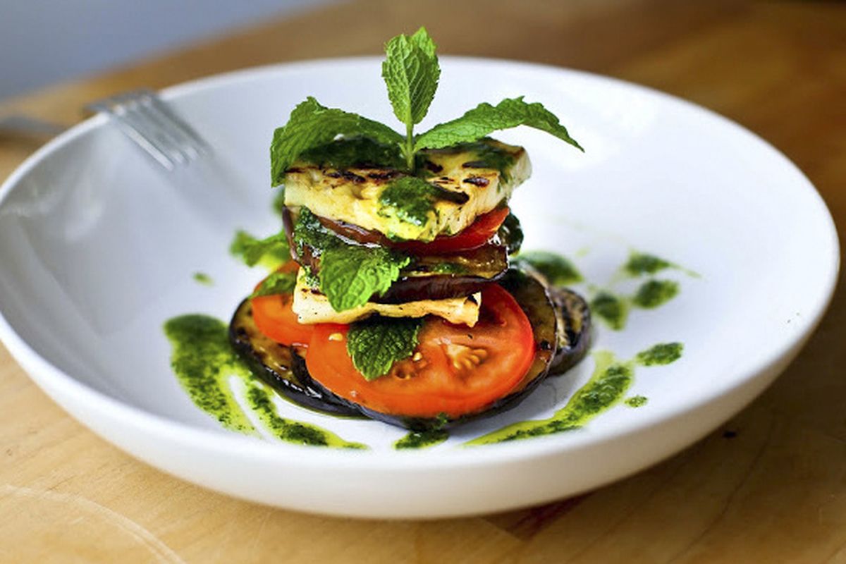 Use a strong sprig of mint or rosemary to spear layers of eggplant, halloumi cheese and tomatoes to serve this salad Napoleon-style. (Sylvia Fountaine)