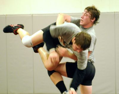 Lucas Chesher, right, a 157-pounder from Central Valley High School, throws his workout partner, D.J. May, during practice.  (Jesse Tinsley / The Spokesman-Review)