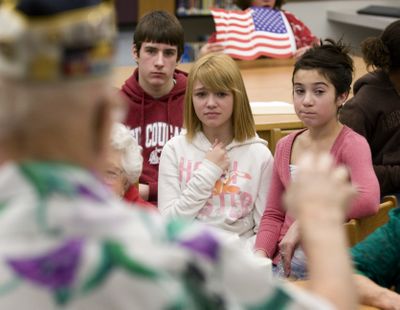 Chase Middle School  seventh-graders Chris Nelson, Hannah Johnson and Tori Domini listen as Pearl Harbor survivor Sid Kennedy tells students about his experience the day the Japanese military attacked the Hawaiian Islands naval base on Dec. 7,  1941.  (Colin Mulvany / The Spokesman-Review)