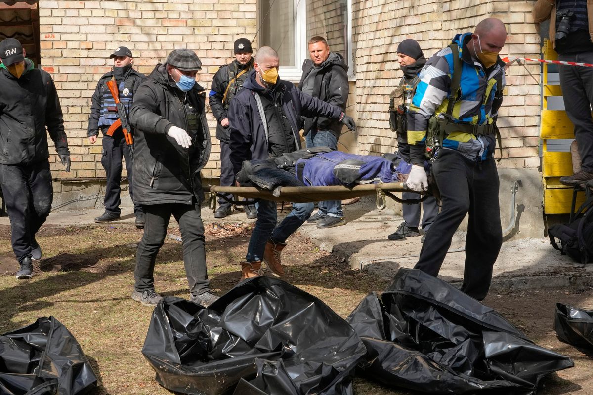 Volunteers collect bodies of murdered civilians, in Bucha, close to Kyiv, Ukraine, on Monday.  (Efrem Lukatsky)