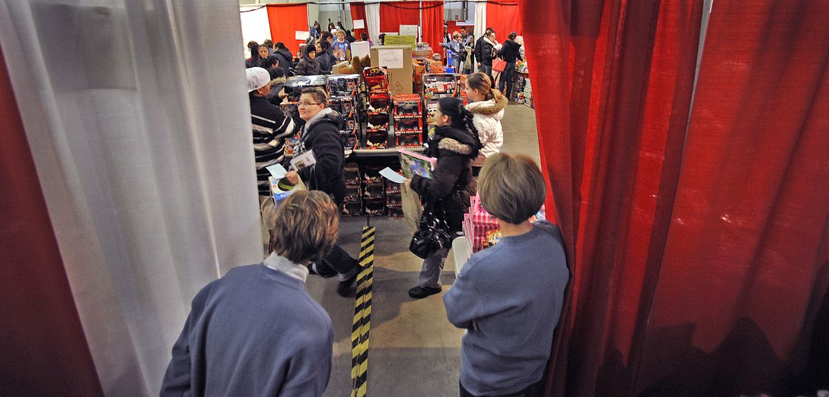 Volunteers Beth Brasch, left, and Linda Solan watch as people file through the toy room to find presents Thursday – opening day of the 10-day Christmas Bureau. (Christopher Anderson)