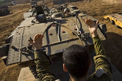 An Israeli armored vehicle maneuvers in a staging area near Israel’s border with the Gaza Strip, in southern IsraelJan. 21.  (Associated Press / The Spokesman-Review)