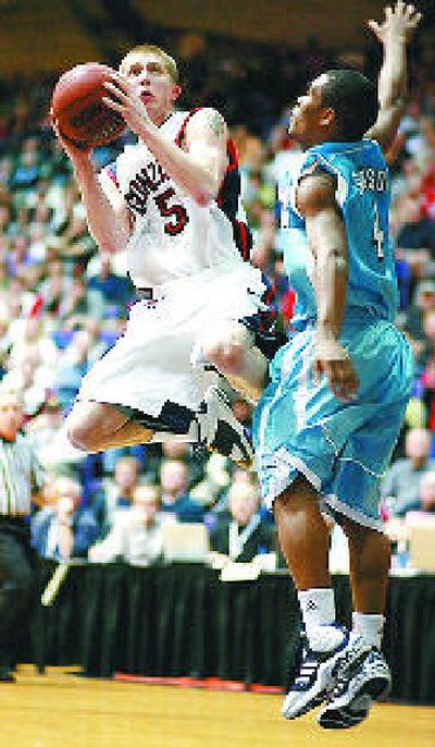 
GU's Derek Raivio drives past Brandon Johnson of San Diego. 
 (Craig Mitchelldyer Special to The S-R / The Spokesman-Review)