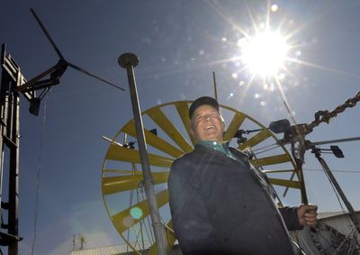 Eduard Ribic is framed in the blades of a windmill at his shop near Airway Heights on April 6. Ribic has been involved in developing, building and selling wind and solar power for almost 30 years.  (CHRISTOPHER ANDERSON / The Spokesman-Review)