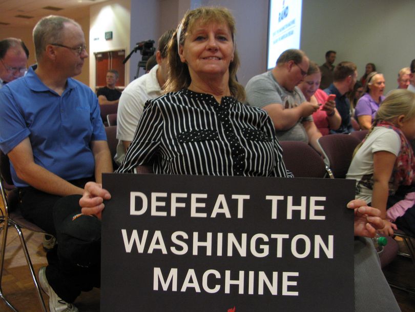 Linda Pfister holds a campaign sign as she waits for Rand Paul to speak in Boise on Thursday (Betsy Z. Russell photo)