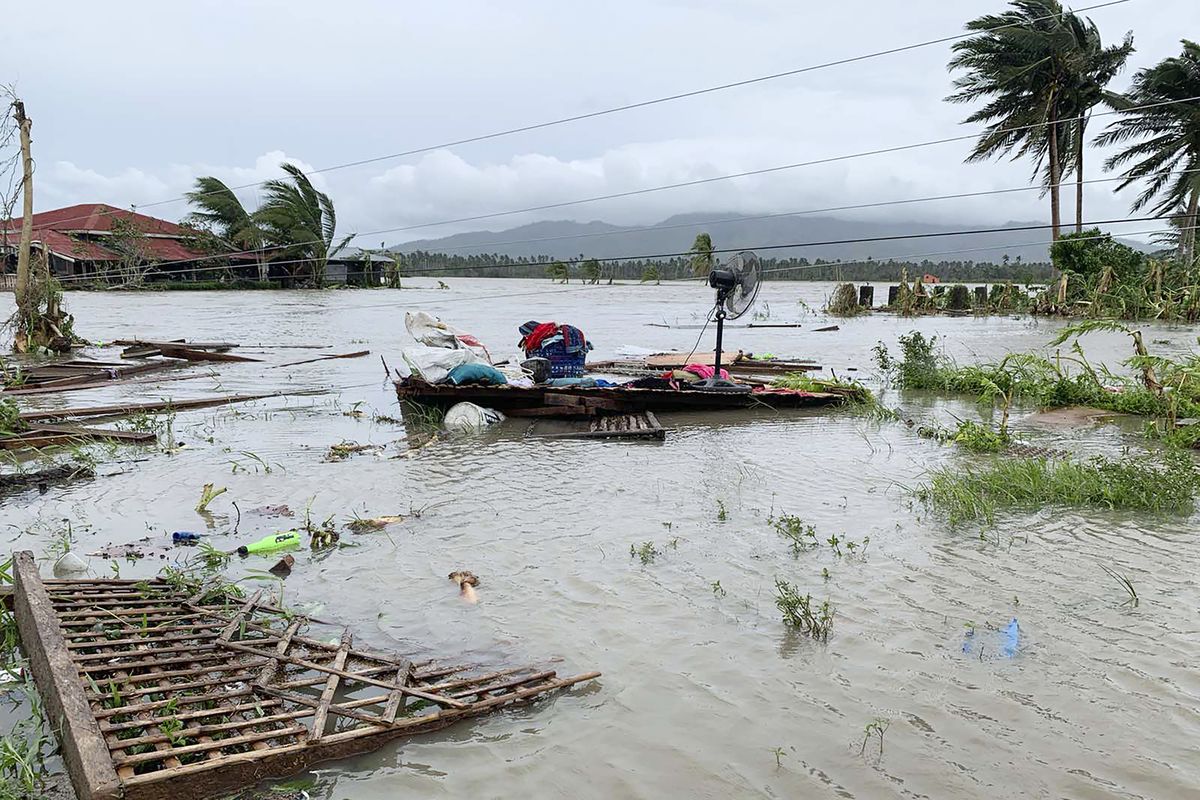 The remains of a house is surrounded by floods in Pola town on the island of Mindoro, central Philippines, Monday, Oct. 26, 2020. A fast-moving typhoon forced thousands of villagers to flee to safety in provinces south of the Philippine capital Monday, flooding rural villages and ripping off roofs, officials said.  (Erik De Castro)