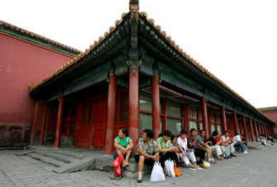 
Visitors to Beijing's Forbidden City on Saturday sit in front of the Starbucks outlet, which was shut down Friday after protests. Associated Press
 (Associated Press / The Spokesman-Review)