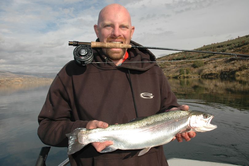 Fishing guide Brian Whitney of Manson holds a fly-caught triploid rainbow trout caught in Lake Rufus Woods on Nov. 3, 2011. (Darrell & Dad's Family Guide Service)