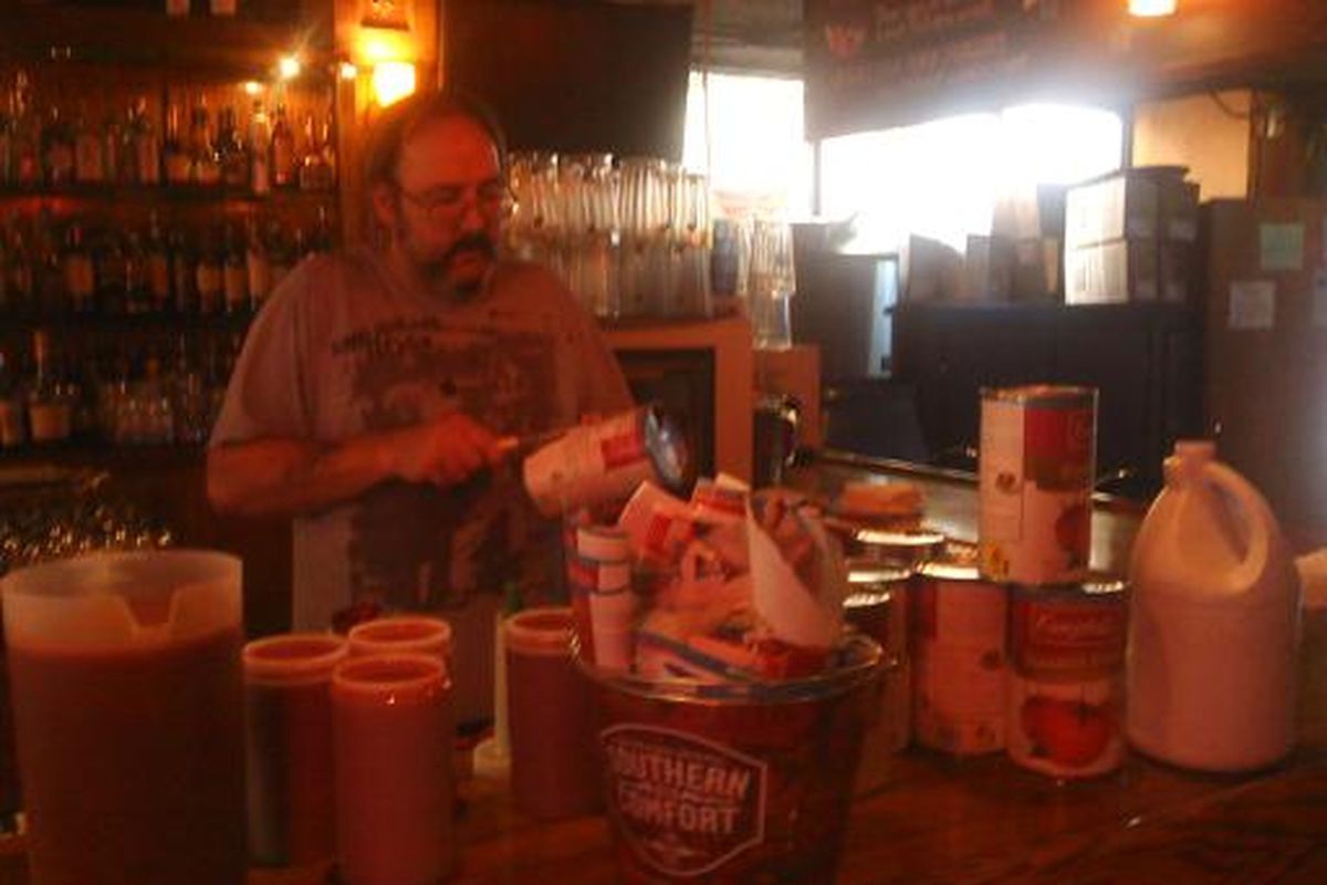 Satellite employee Edward Liner makes Bloody Mary mix for the big weekend breakfast crowd. Cans of tomato juice are recycled and the labels given to Grant Elementary.  (Courtney Dunham / Down to EarthNW Correspondent)
