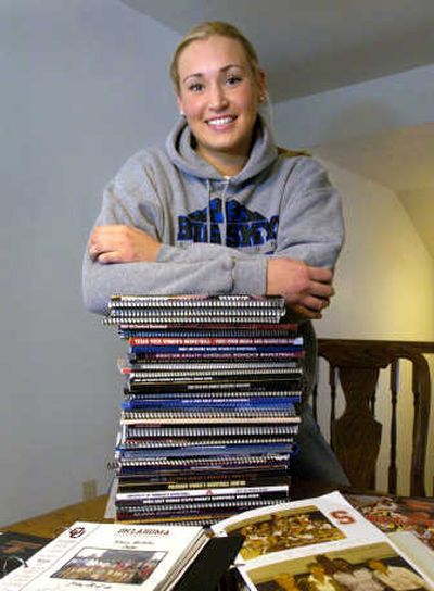 
Joslyn Tinkle poses with media guides, letters from recruiters. Associated Press
 (Associated Press / The Spokesman-Review)