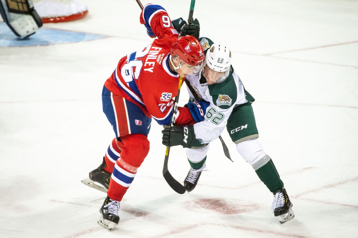 Jack Finley (26) of the Spokane Chiefs battles Michal Gut (62) of the Everett Silvertips during a WHL game at the Spokane Arena on Oct. 6, 2019. (Libby Kamrowski/THE SPOKESMAN-REVIEW)