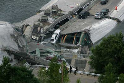 
Wrecked vehicles still line the I-35W bridge Thursday. Associated Press
 (Associated Press / The Spokesman-Review)