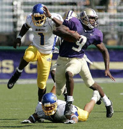 
Huskies tailback Louis Rankin evades San Jose State defenders Trae Jackson (1) and Donald Richardson on the way to a 68-yard touchdown run in the fourth quarter. 
 (Associated Press / The Spokesman-Review)