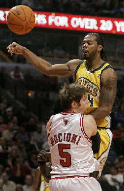 
SuperSonics' Chris Wilcox, top, collides with Bulls' Andres Nocioni.
 (Associated Press / The Spokesman-Review)