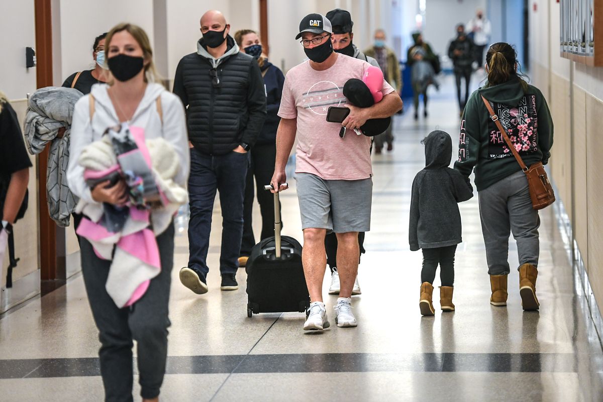 After returning from Hawaii and still wearing his shorts, Mark Hattenburg, of Colbert, Wa., heads to baggage at Spokane International Airport, Wednesday, Dec. 23, 2020.  (DAN PELLE/THE SPOKESMAN-REVIEW)