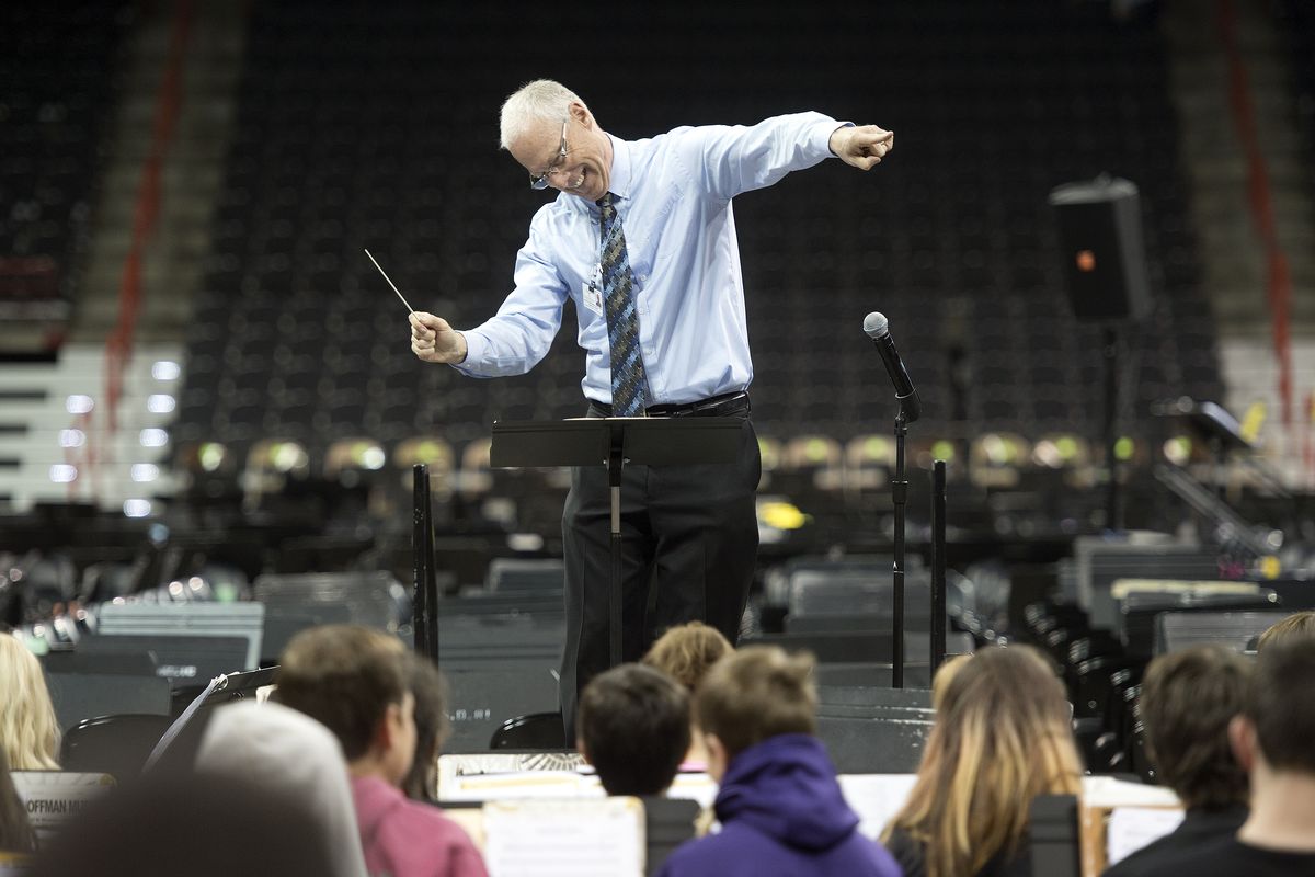 Dave Weatherred conducts the last notes for “Along Came a Spider” during a Tuesday morning practice for the Band and Strings Spectacular at the Spokane Veterans Memorial Arena. Weatherred has organized the event for the past 18 years. (Dan Pelle)