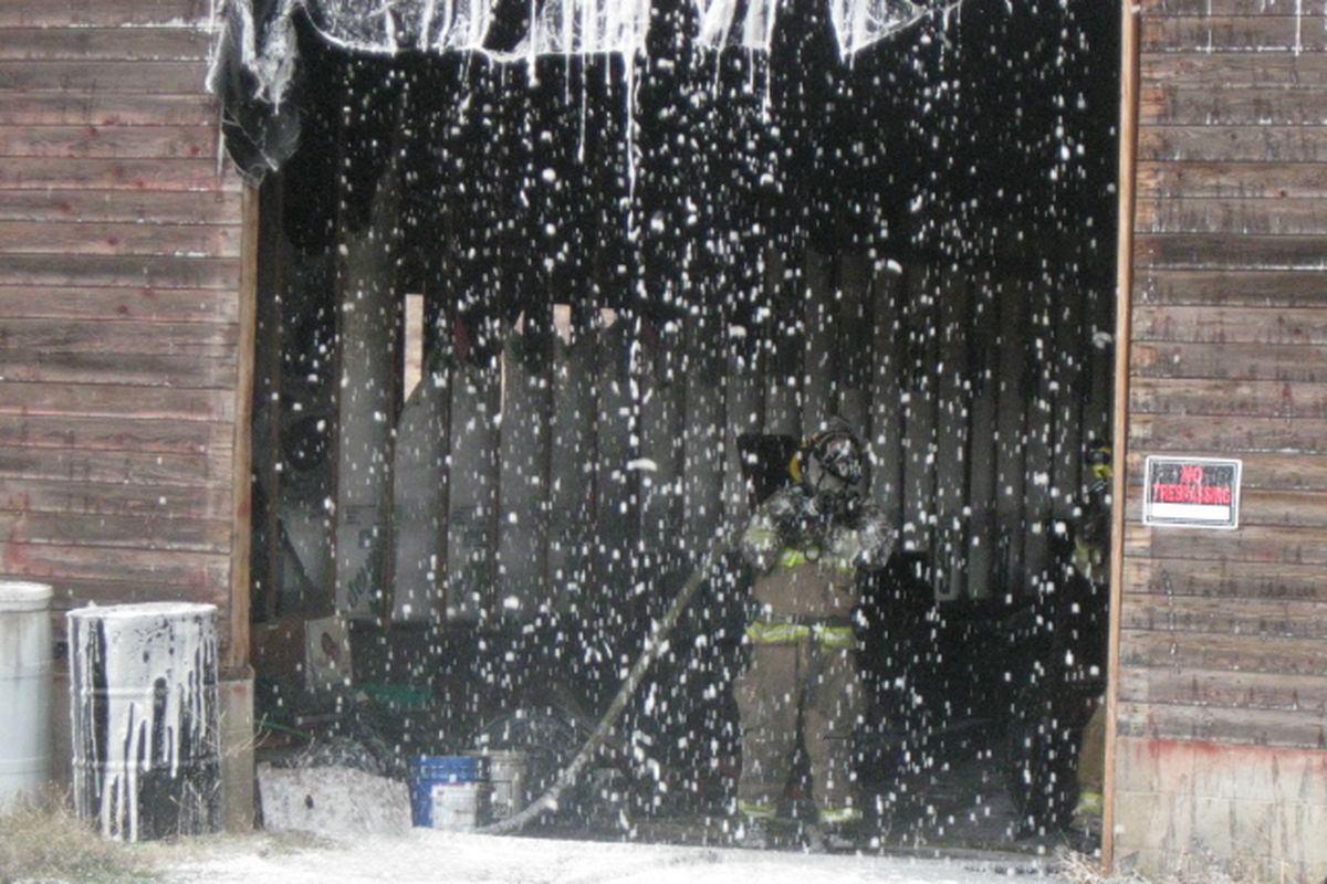 A firefighter works on a barn fire at Wheelers Produce, 21301 E. Trent, on Nov. 3, 2012. (Spokane Valley Fire Department)