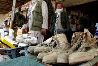 
Western military boots are displayed at a shop selling military goods in front of the U.S. air base in Bagram, north of Kabul, Afghanistan, on Wednesday.
 (Associated Press / The Spokesman-Review)