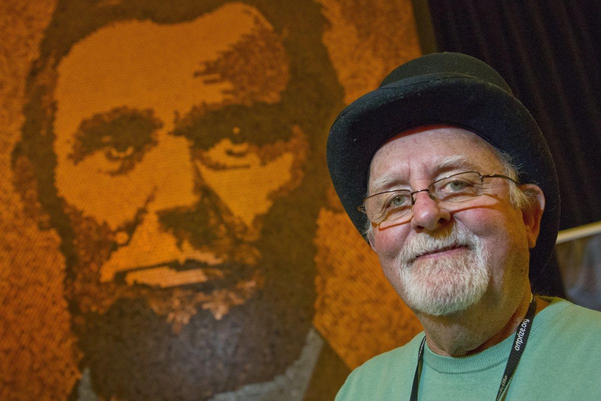 In this Oct. 1, 2017 photo, Richard Schlatter stands next to his entry "A. Lincoln" in Grand Rapids, Mich. Schlatter accepted the $200,000 Public Vote Grand Prize for "A. Lincoln" during the ArtPrize Awards Oct. 6. (Cory Morse / Associated Press)