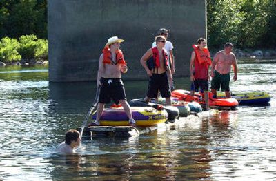 
From left to right, Zach Olson, Trevor Clark, Ryan Rollins, Darrin VanBebber, Scott Doty and Gerad Canright watch for the shore under the Barker Road Bridge in Spokane Valley on Thursday evening. The group put in at the state line and was floating to Sullivan Road. 
 (Liz Kishimoto / The Spokesman-Review)