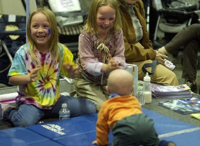 
Halie Olney, 7, and her twin sister, Sadie, cheer on their 9-month-old brother, Elijah, during the Baby Crawl at the Spokane Baby Fair at the Spokane Convention Center on Sunday. Elijah won his heat and went on to the finals.
 (Liz Kishimoto / The Spokesman-Review)