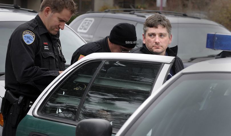 Christopher J. Cook is taken into custody near 29th Avenue and Fiske Street by police after a short car chase Friday, Nov. 13, 2009. Cook is a suspect in the robbery of an AmericanWest bank branch Thursday in Spokane Valley. (Christopher Anderson / chrisa@spokesman.com)
