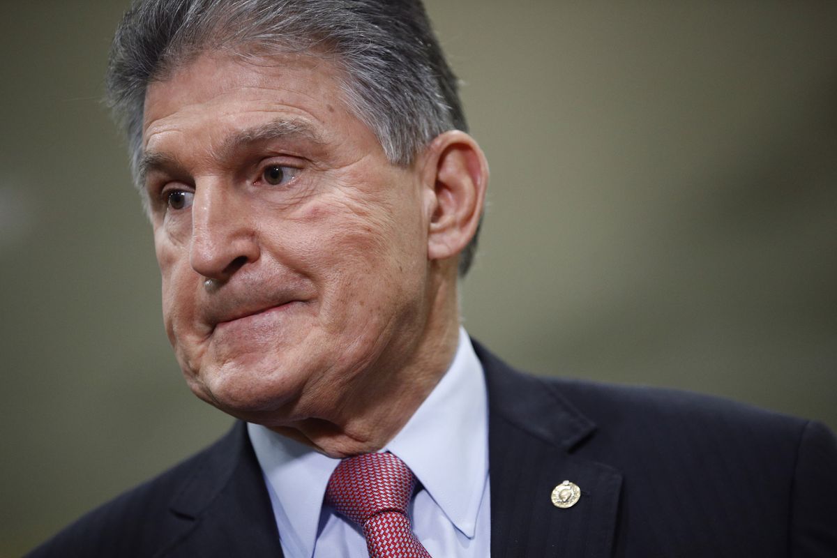 FILE - In this Feb. 5, 2020, file photo, Sen. Joe Manchin, D-W.Va., speaks with reporters on Capitol Hill in Washington. A bipartisan group of lawmakers, including Manchin, is putting pressure on congressional leaders to accept a split-the-difference solution to the months-long impasse on COVID-19 relief in a last-gasp effort to ship overdue help to a hurting nation before Congress adjourns for the holidays.  (Patrick Semansky)