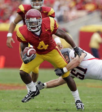 
USC's Joe McKnight breaks a tackle. Associated Press
 (Associated Press / The Spokesman-Review)