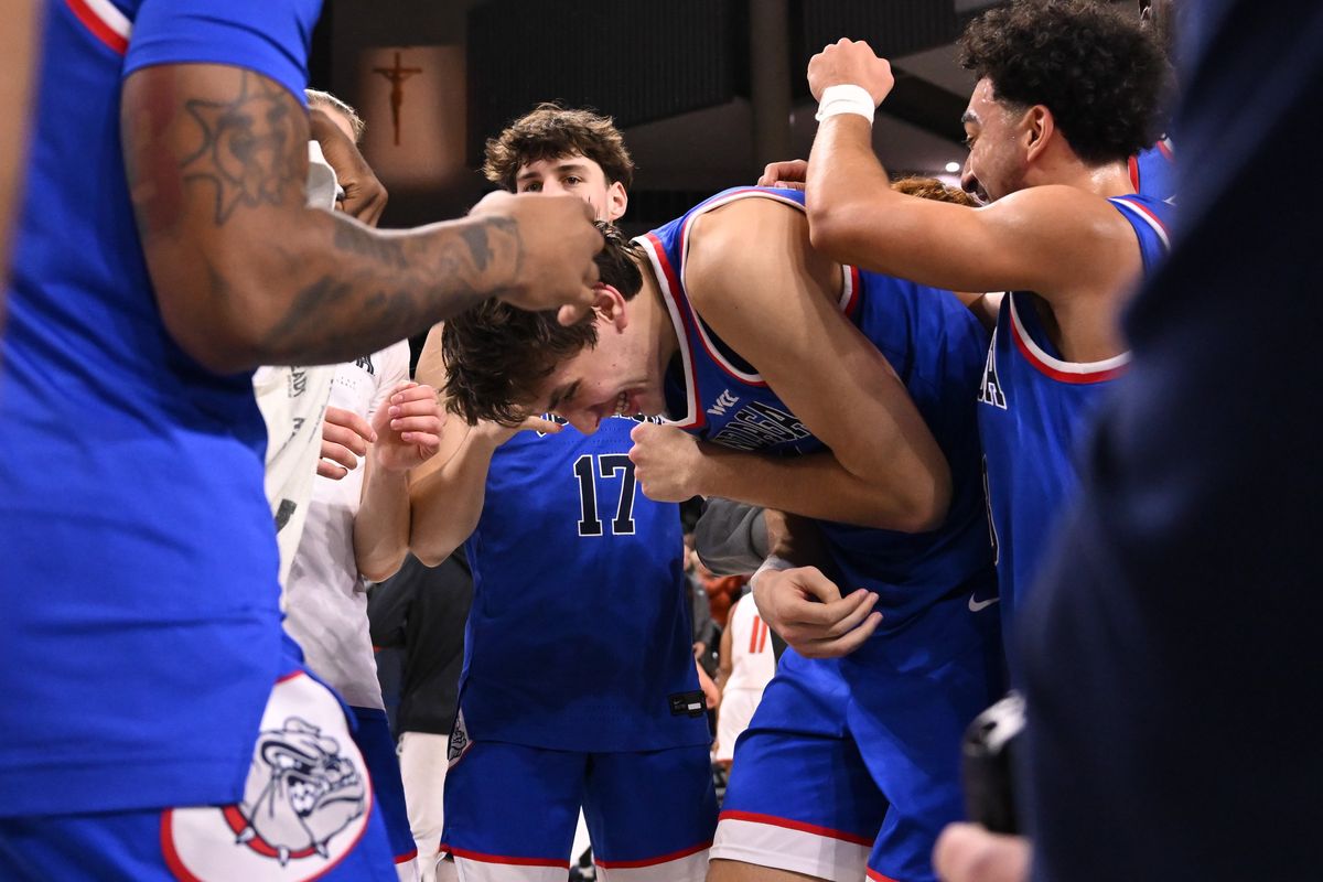 Gonzaga Bulldogs forward Braden Huff (34) is mobbed by teammates after defeating the Campbell Fighting Camels during the second half of a college basketball game on Wednesday, Dec 17, 2025, at McCarthey Athletic Center in Spokane, Wash. Gonzaga won the game 98-70.  (Tyler Tjomsland / The Spokesman-Review)