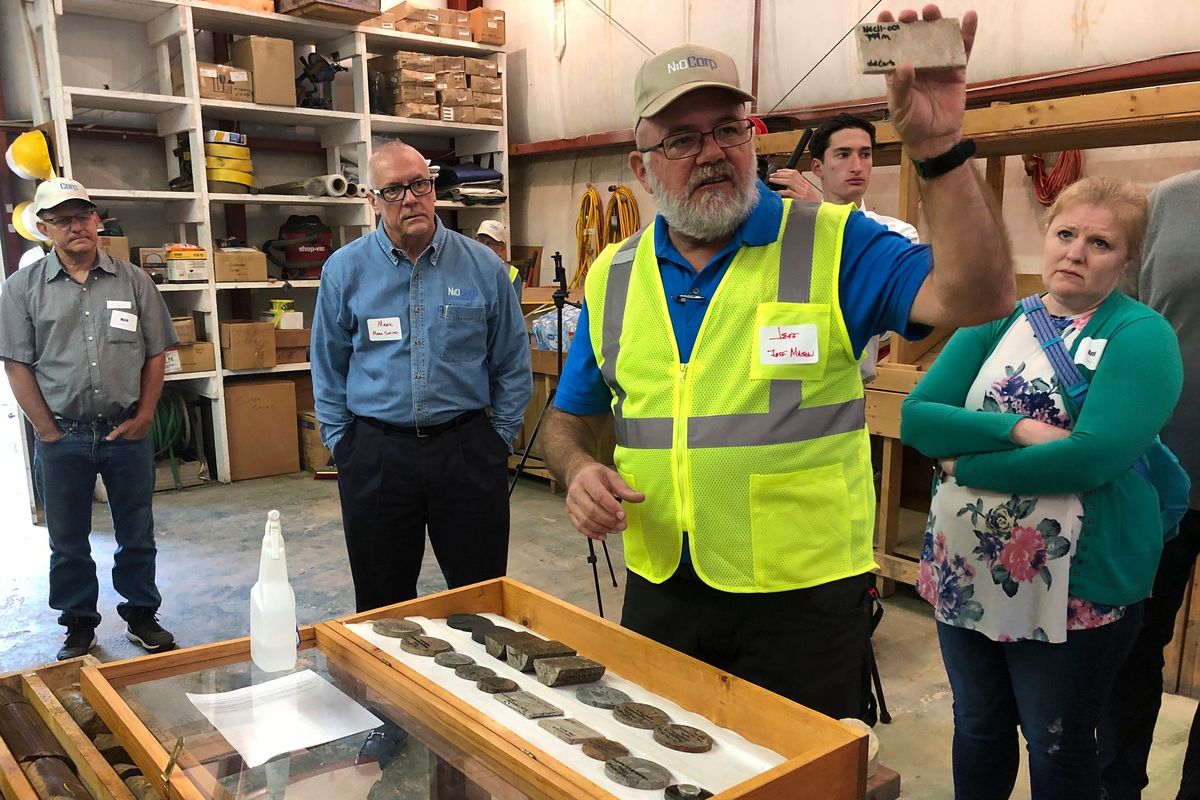 NioCorp Corporate Controller Jeff Mason shows investors a rock sample while the company