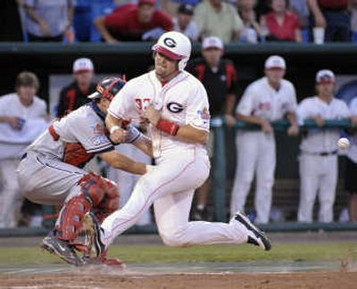 
Georgia's Rich Poythress, right, reaches home on a double by Matt Cerione in the eighth inning. Associated Press
 (Associated Press / The Spokesman-Review)