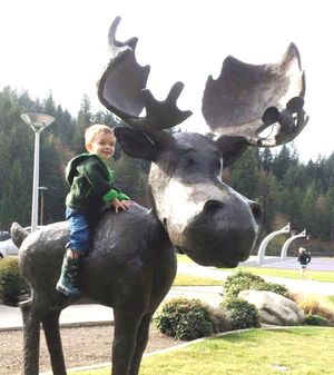 A small boy enjoys one of the many pieces of public art in Coeur d'Alene -- a downtown sculpture depicting the popular Mudgy & Millie story book characters.