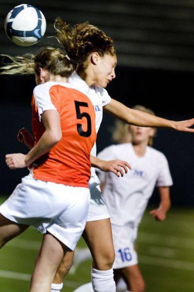 LC’s Annie Pokorny, left, and Mead’s Jazmine Redmon clash. (Colin Mulvany / The Spokesman-Review)