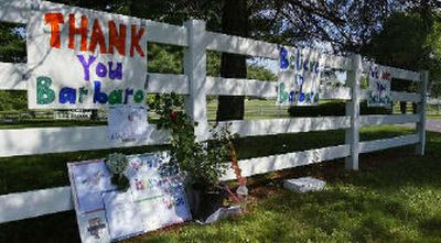 
Signs supporting Barbaro hang on a fence outside the surgery facility Sunday. 
 (Associated Press / The Spokesman-Review)