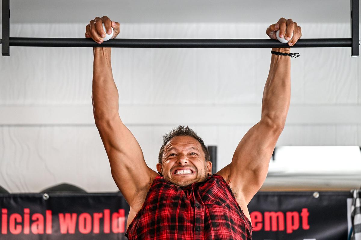 After completing 31 grappler pullups in less than one minute, Lance Pecht strains on his 32nd attempt Sunday at Body Unlimited Fitness in Spokane Valley. Pecht beat the previous Guinness World Record of 29.  (Dan Pelle/For The Spokesman-Review)