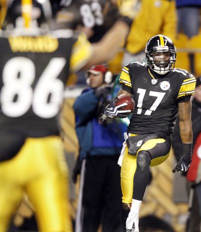 Steelers WR Mike Wallace, right, celebrates catching the game-winning touchdown pass as time expired. (Associated Press)