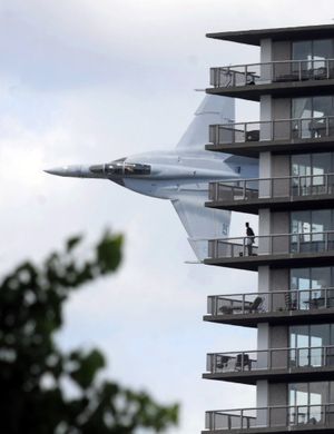 ORG XMIT: MIDTN101 A Navy jet from the Naval Air Station Oceana in Virginia passes an apartment building during tactical demonstration flyover as part of the 2009 Chrysler Jeep Superstores APBA Detroit Gold Cup race, Sunday July 12, 2009 along the Detroit River in Detroit. (AP Photo/The Detroit News, Steve Perez) ** DETROIT FREE PRESS OUT ** (Steve Perez / The Spokesman-Review)