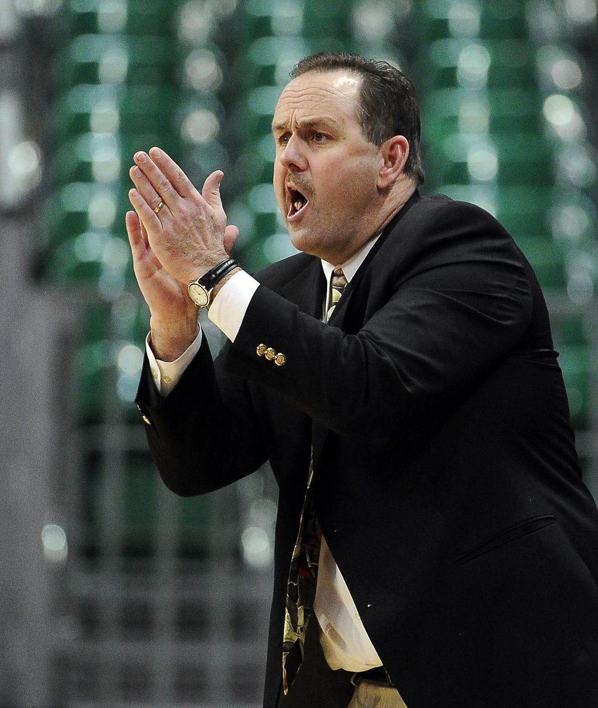 Idaho coach Don Verlin applauds his team during the second half of an NCAA college men