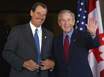 
President  Bush waves as Mexico's President Vicente Fox arrives for a meeting in Waco, Texas, in  March  2005. Associated Press
 (Associated Press / The Spokesman-Review)