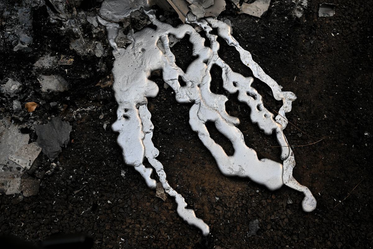 Melted metal from Scott Montney’s Ford pickup is starkly contrasted against charred earth on Aug. 20 after the Gray fire destroyed the Montneys’ home on Silver Lake near Medical Lake.  (Tyler Tjomsland/The Spokesman-Review)